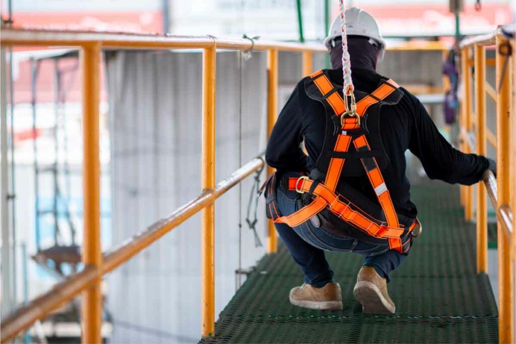 Construction worker wearing safety harness