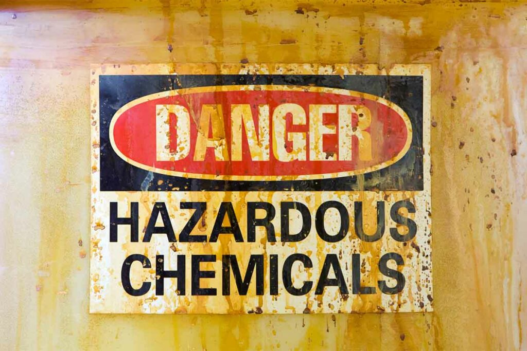 "Danger: Hazardous Chemicals" sign on a barrel